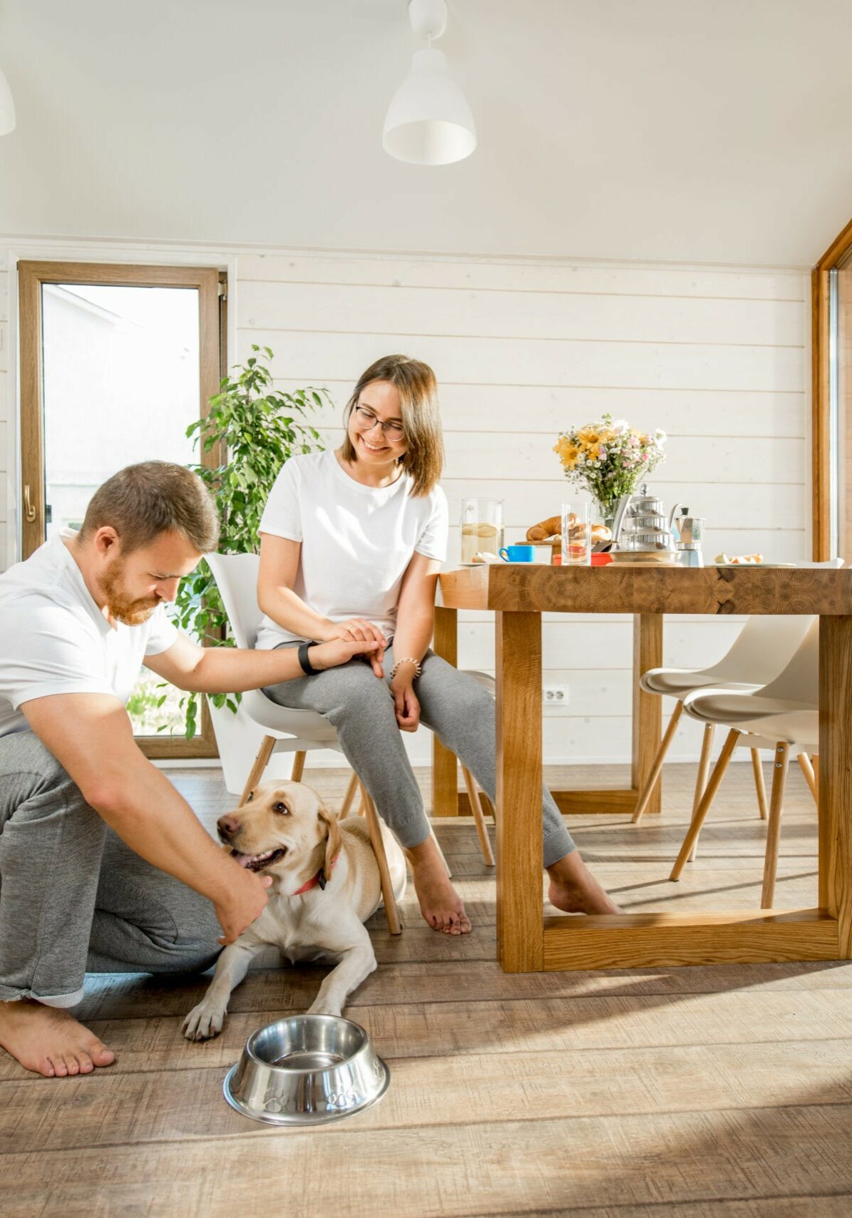 Young couple with dog at home | Holmes Carpet Center